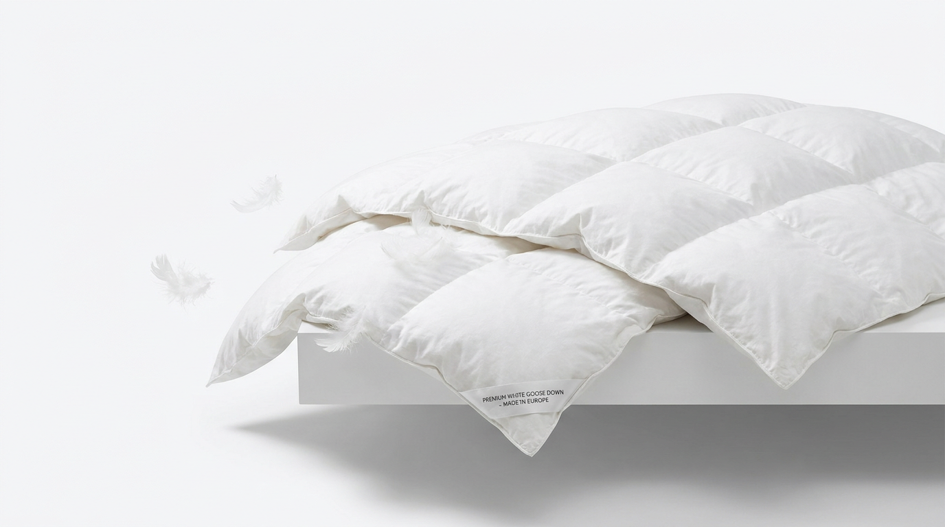 Extremely fluffy white goose down duvet against a white background — the visible loft illustrates the relationship between fill power and insulating air volume