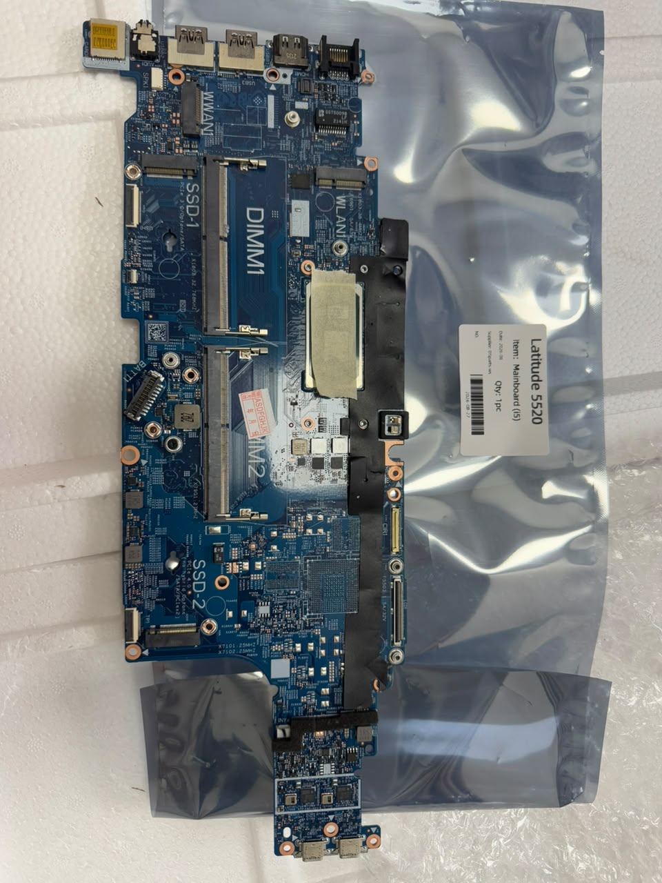 Dell Latitude 5520 laptop mainboard with processor and connectors shown on anti-static bag.
