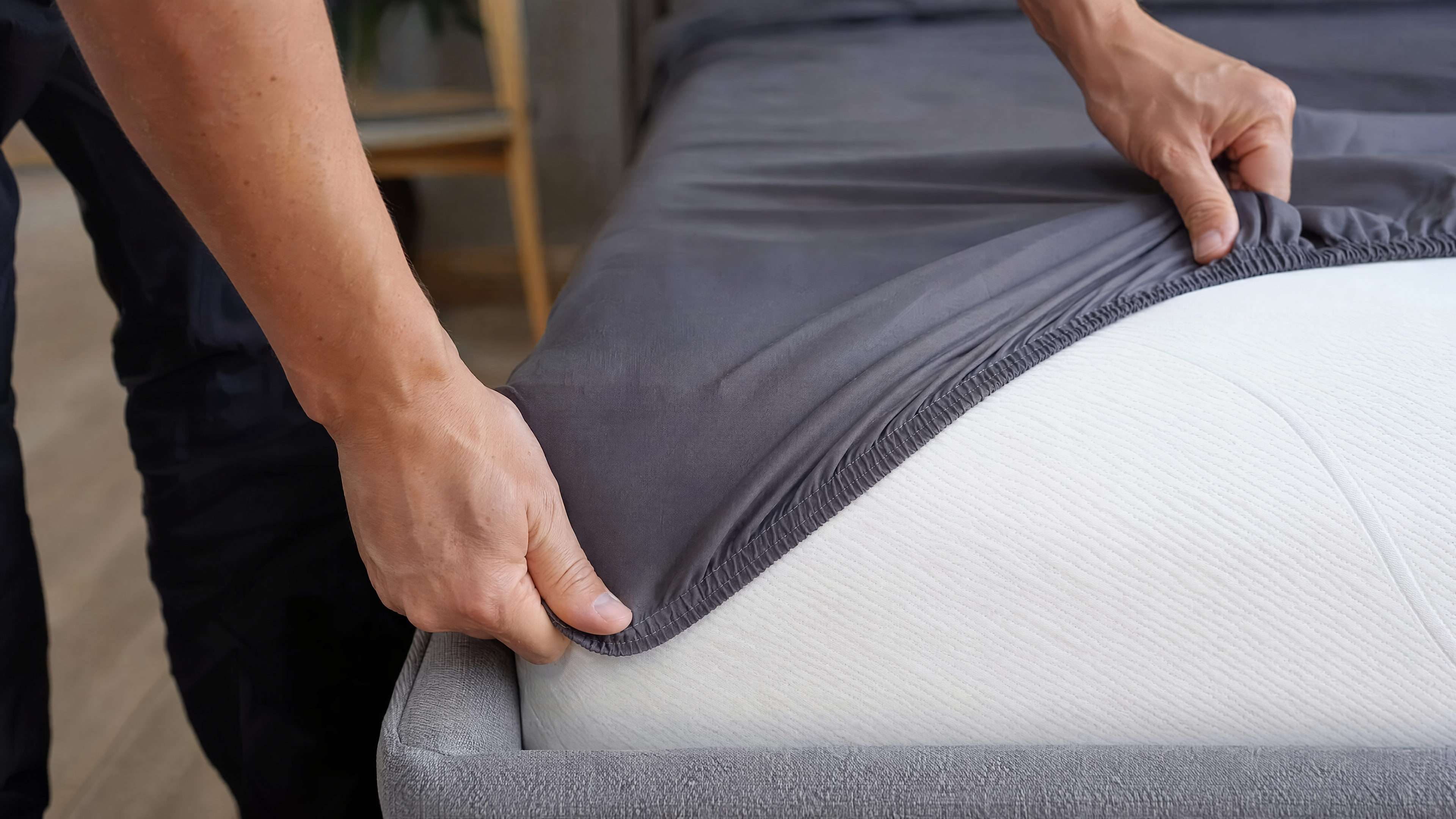 Close-up of LuxClub's 18-21 inch deep pocket fitted sheet with full-perimeter heavy-duty elastic hugging mattress corner under tension