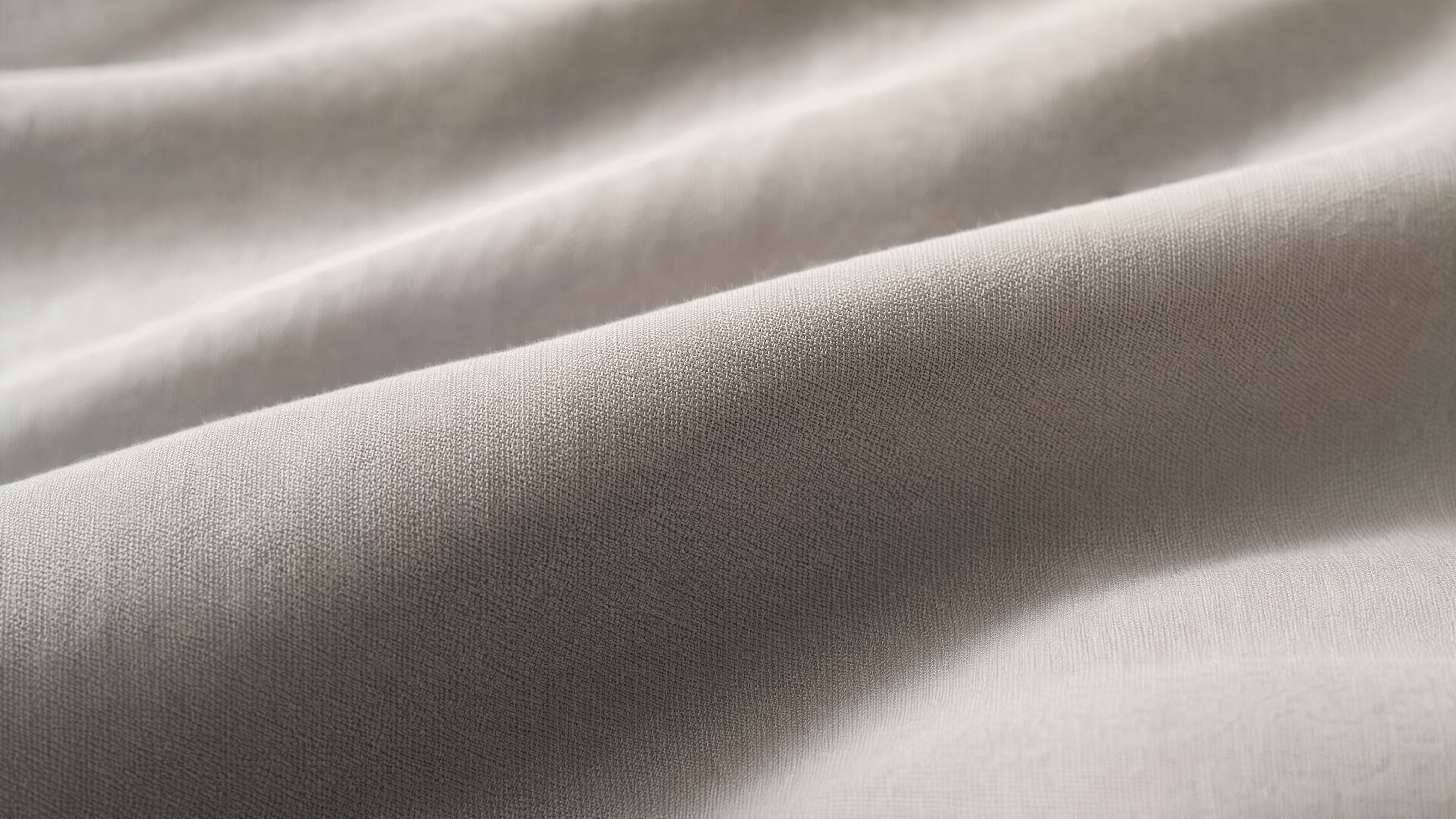 Close-up macro shot of buttery-soft double-brushed microfiber sheet fabric with silky-smooth cashmere-like texture