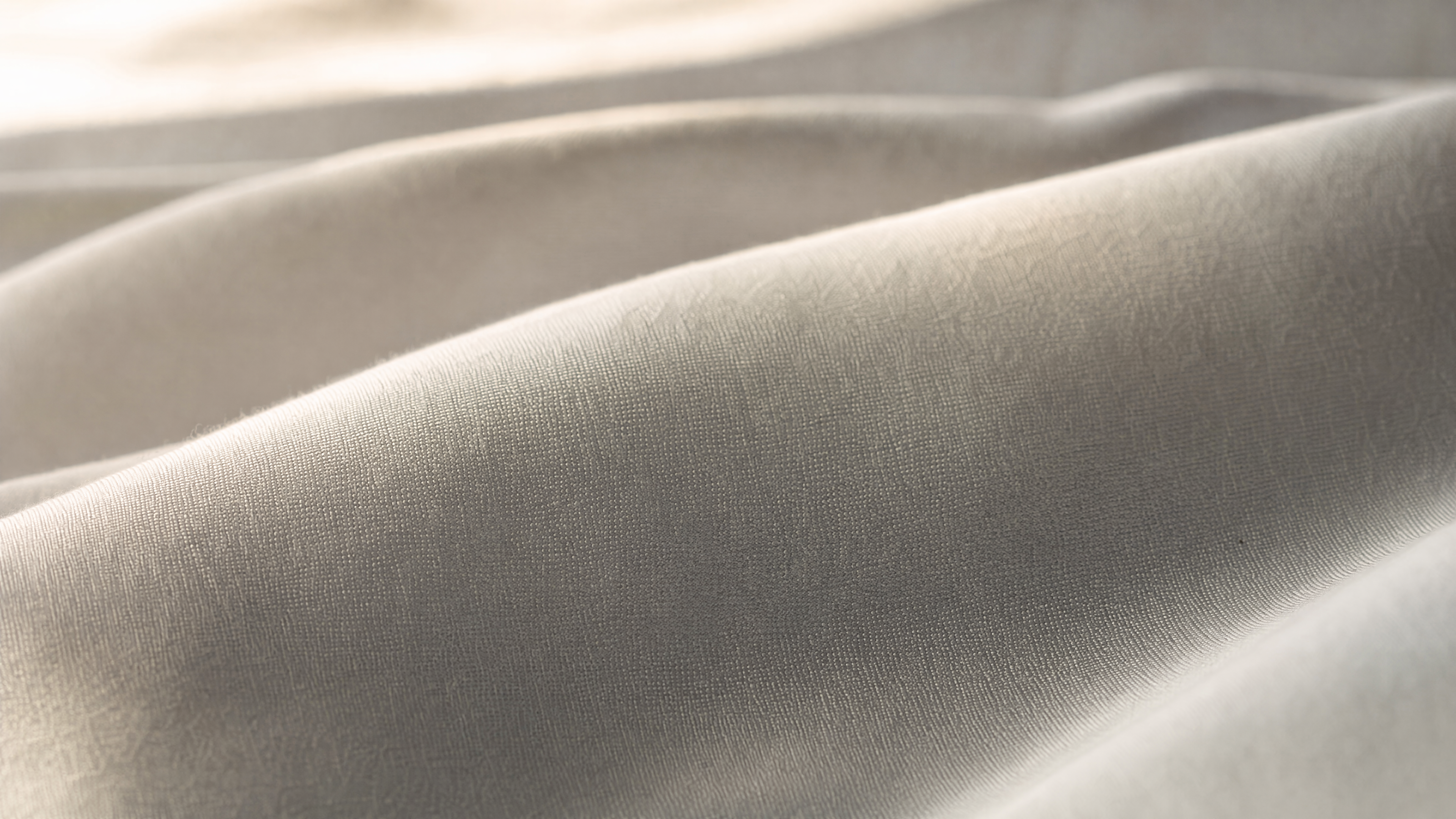 Buttery-soft double-brushed microfiber sheet fabric close-up in natural light